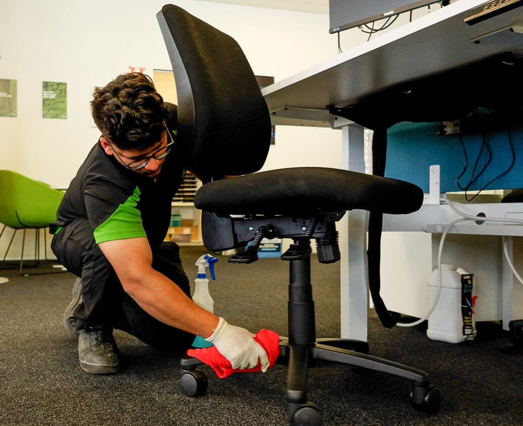 person cleaning the office chair